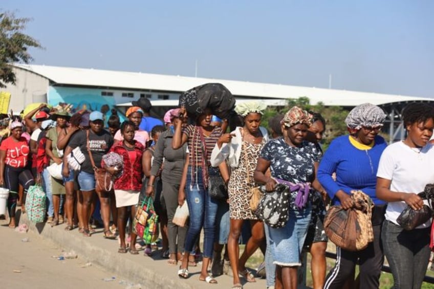 Haitians cross the border into the Dominican Republic on March 8, 2024 to take part in the