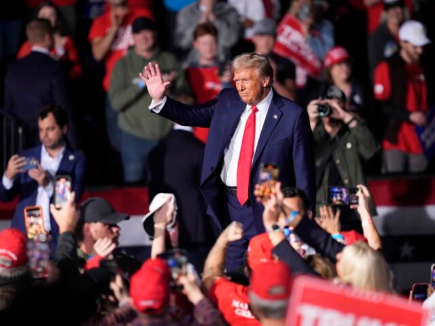 Republican presidential nominee former President Donald Trump waves to the crowd after spe