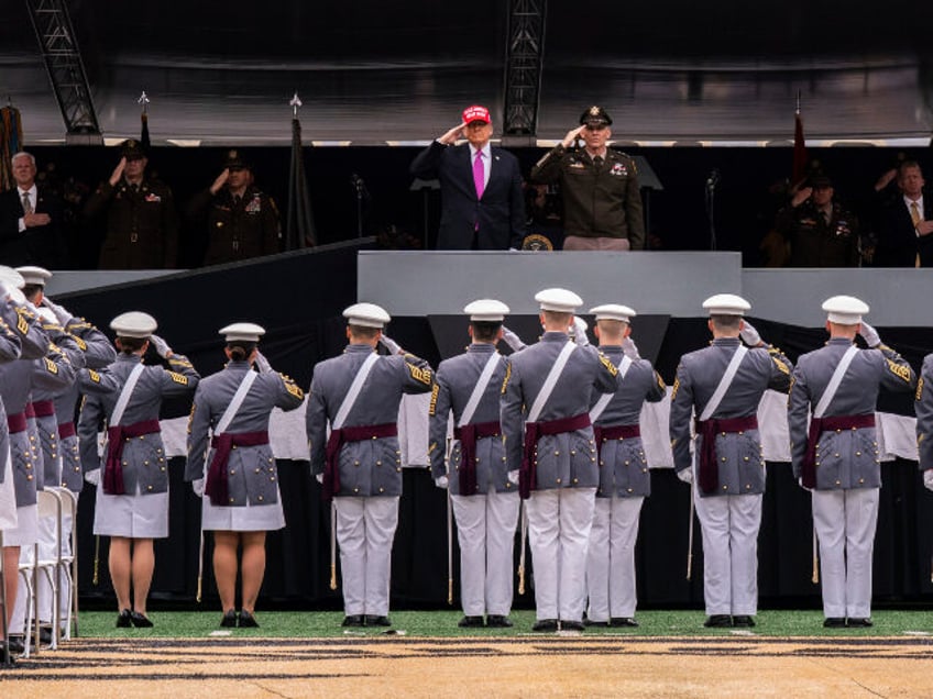 President Donald Trump salutes alongside Lieutenant General Steven W. Gilland during the U