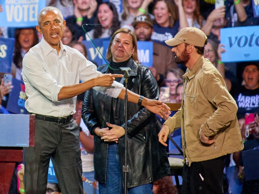 Rapper Eminem introduces former president Barack Obama during a rally to supporters of Vic