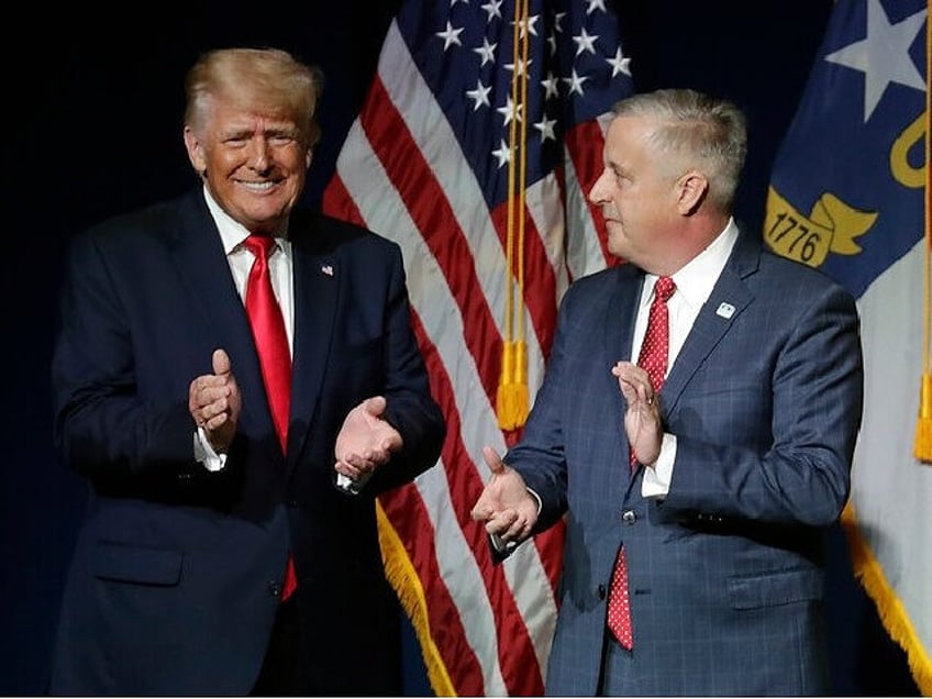 Former President Donald Trump, left, is welcomed by Michael Whatley, Chairman of the N.C.