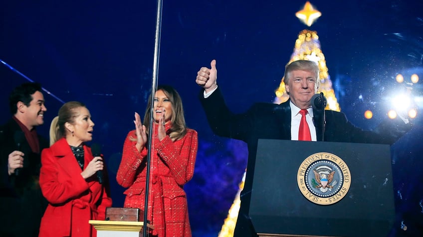 President Donald Trump and first lady Melania Trump, cheer after lighting the 2017 National Christmas Tree during the National Christmas Tree lighting ceremony at the Ellipse near the White House in Washington, Thursday, Nov. 30, 2017. With the president and the first lady are hosts for the event, Kathie Lee Gifford and actor Dean Cain. (AP Photo/Manuel Balce Ceneta)