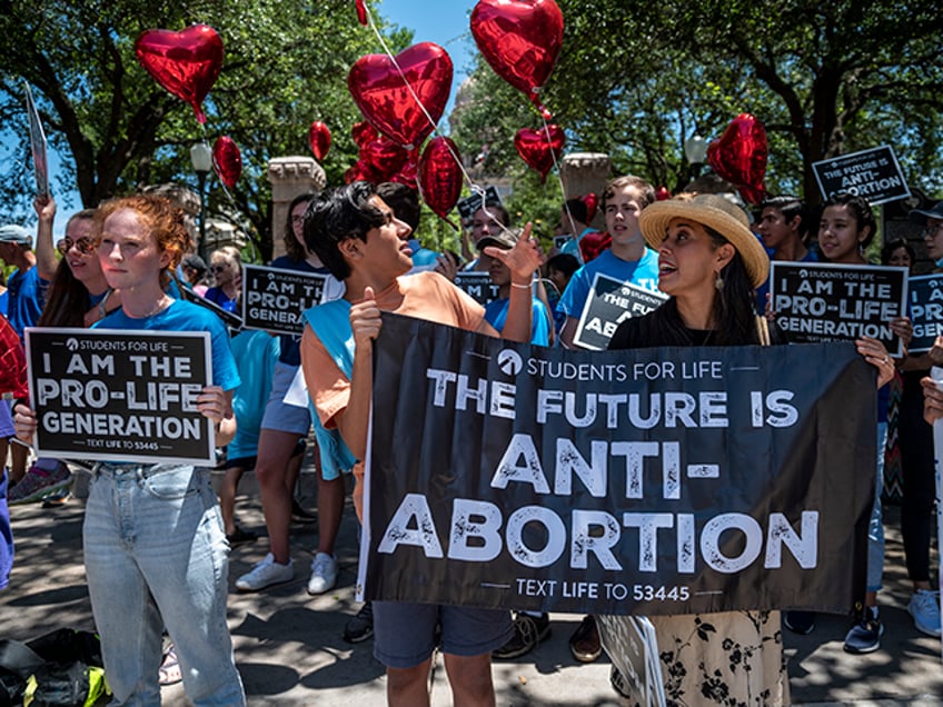 Pro-life protesters stand near the gate of the Texas state capitol at a protest outside the Texas state capitol on May 29, 2021 in Austin, Texas. Thousands of protesters came out in response to a new bill outlawing abortions after a fetal heartbeat is detected signed on Wednesday by Texas Governor Greg Abbot. (Photo by Sergio Flores/Getty Images)