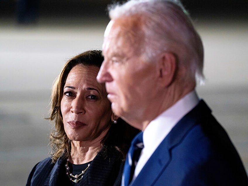 Vice President Kamala Harris, left, watches as President Joe Biden speaks to members of th