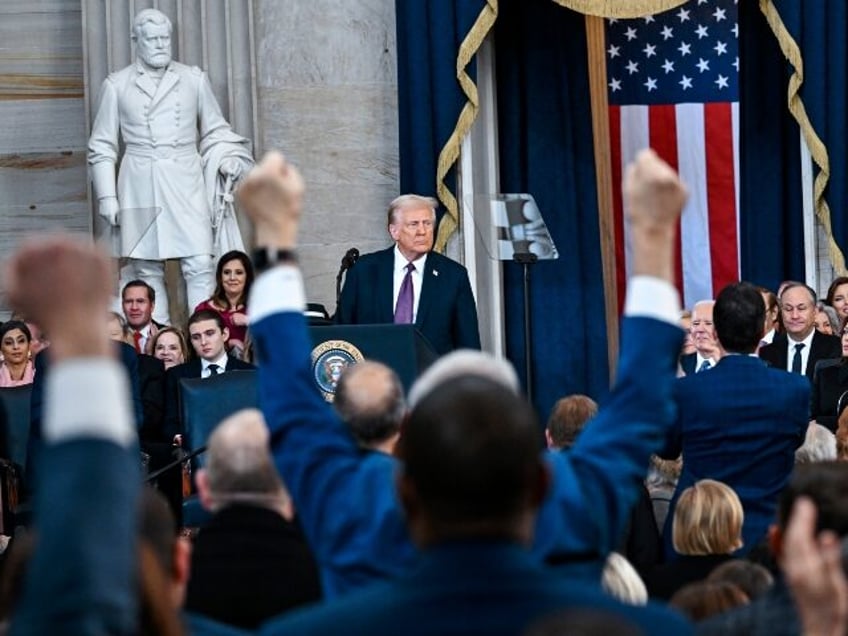 Attendees cheer as President Donald Trump speaks after taking the oath of office during th