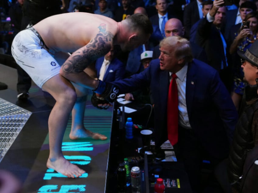 LAS VEGAS, NEVADA - DECEMBER 16: (L-R) Colby Covington talks to former United States presi