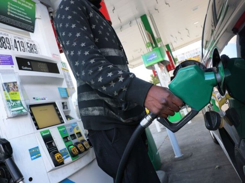 A person prepares to pump gas at a BP gas station on Coney Island Avenue on October 19, 20