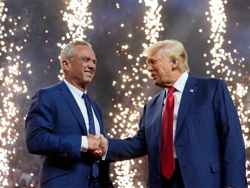 Republican presidential nominee former President Donald Trump shakes hands with Independen