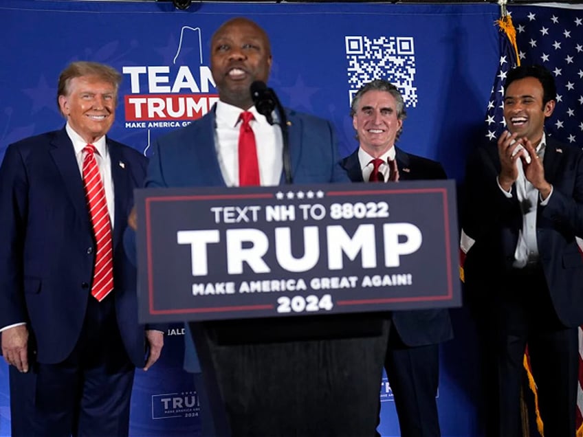 Sen. Tim Scott, R-S.C., speaks as Republican presidential candidate former President Donald Trump listens with North Dakota Gov. Doug Burgum and Vivek Ramaswamy listen during a campaign event in Laconia, N.H., Monday, Jan. 22, 2024. (AP Photo/Matt Rourke)