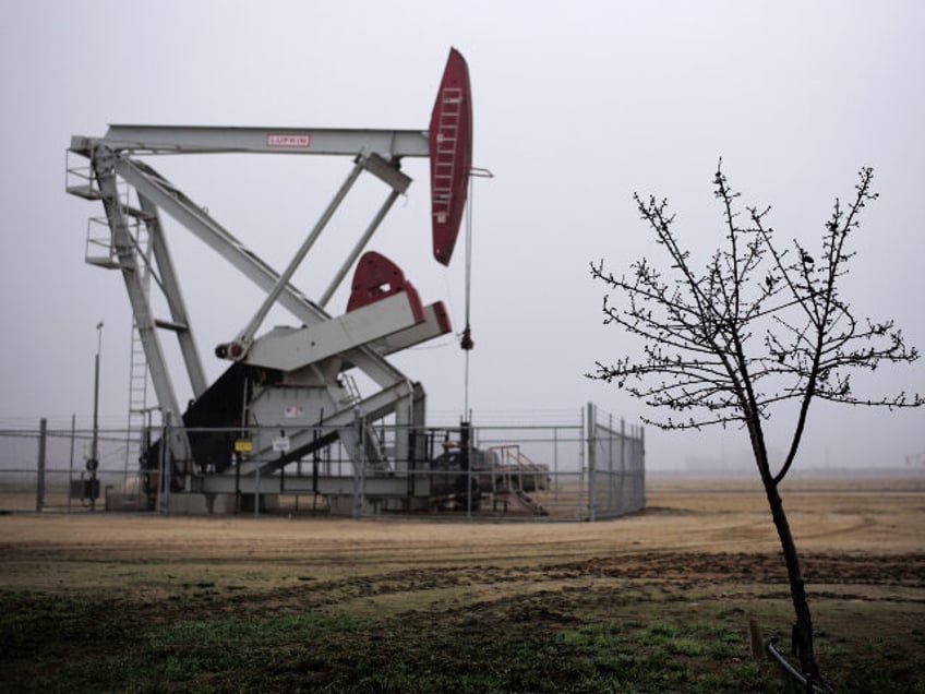 This Jan. 15, 2015 file photo shows an almond tree by a pumpjack in Shafter in California&