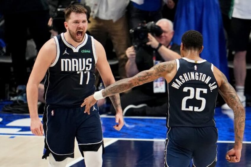 Luka Doncic and P.J. Washington of the Dallas Mavericks celebrate during the final minute