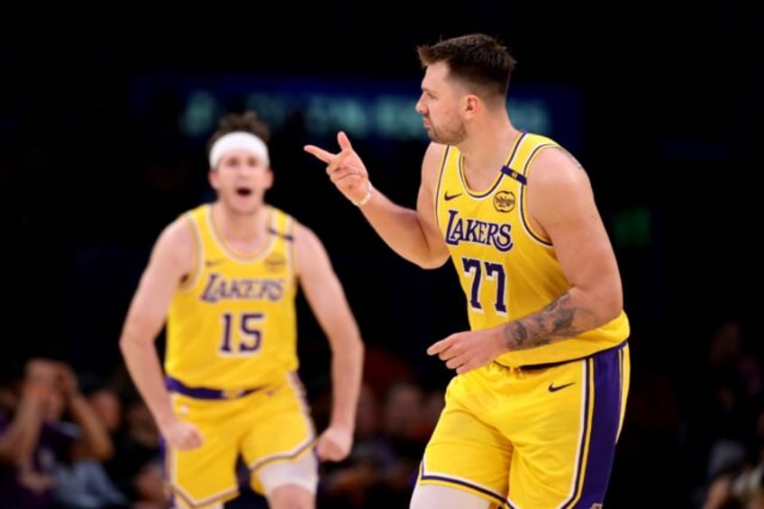 Luka Doncic celebrates a three-pointer with team-mate Austin Reaves in the Los Angeles Lak