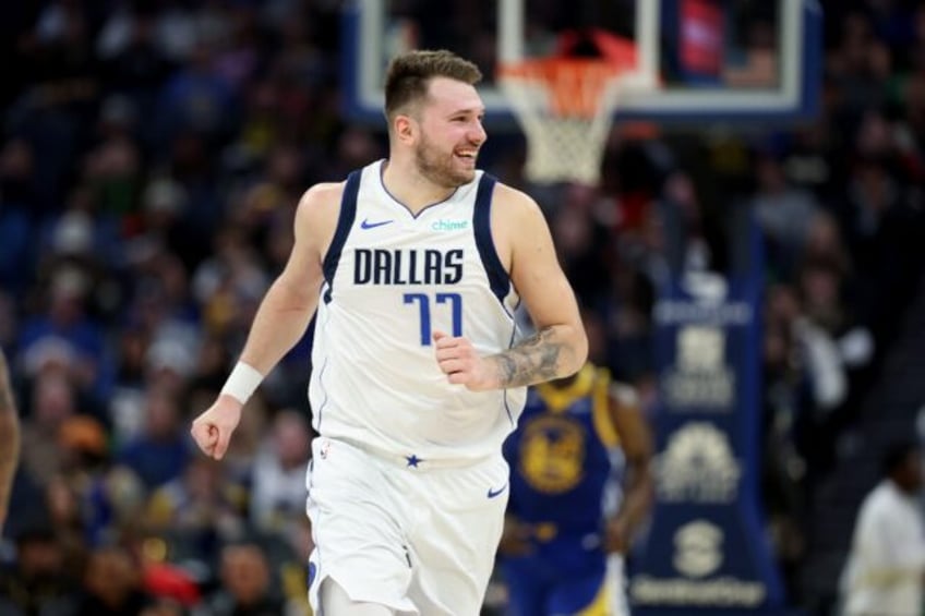 Luka Doncic reacts after scoring for the Dallas Mavericks in an NBA game against the Golde