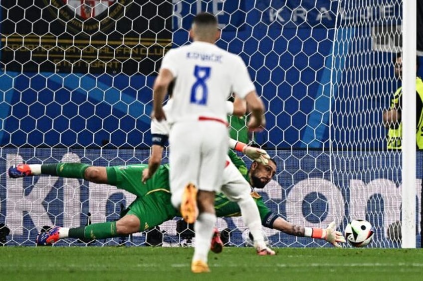Gianluigi Donnarumma saves Luka Modric's penalty