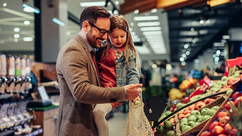 Dad and daughter grocery shopping