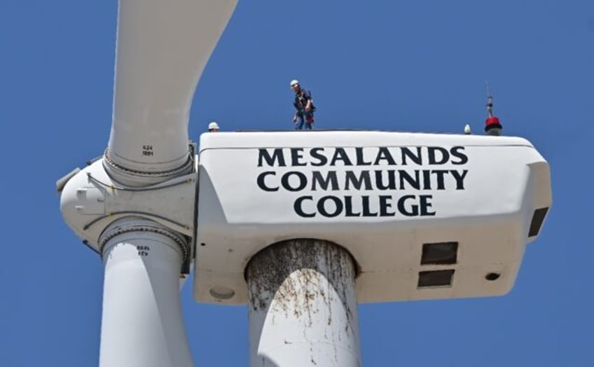 Wind turbine technician Terrill Stowe stands on the nacelle, which houses the gearbox and