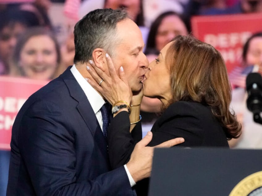 Vice President Kamala Harris kisses her husband second gentleman Doug Emhoff before Presid