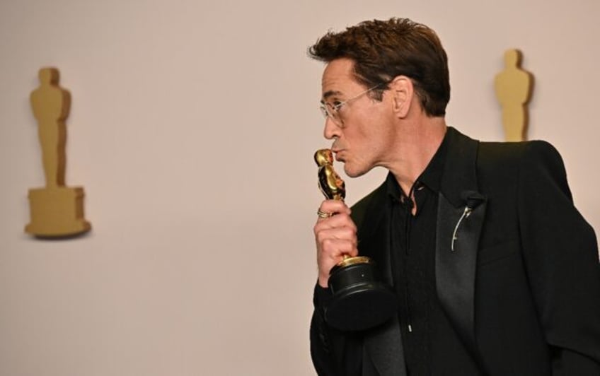 Robert Downey Jr. poses with his Oscar for best supporting actor for 'Oppenheimer'