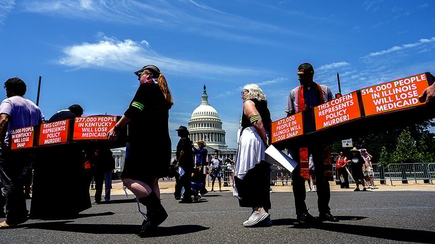 Demonstrators protest at US Capitol carrying coffins