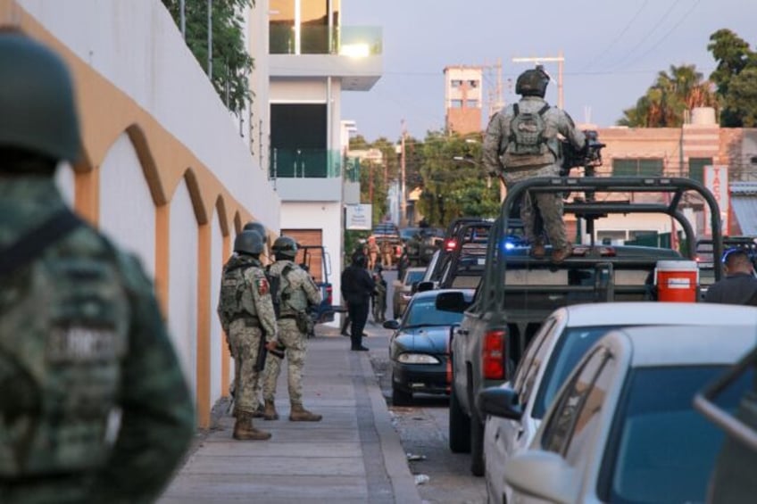 Mexican soldiers patrol the streets of Culiacan, the state capital of cartel bastion Sinal