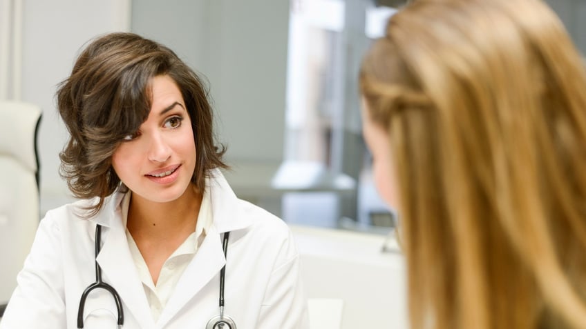 Female doctor explaining diagnosis to her female patient