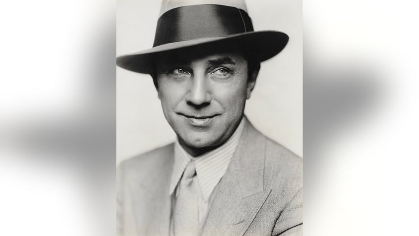 A close-up of Bela Lugosi in a suit and fedora