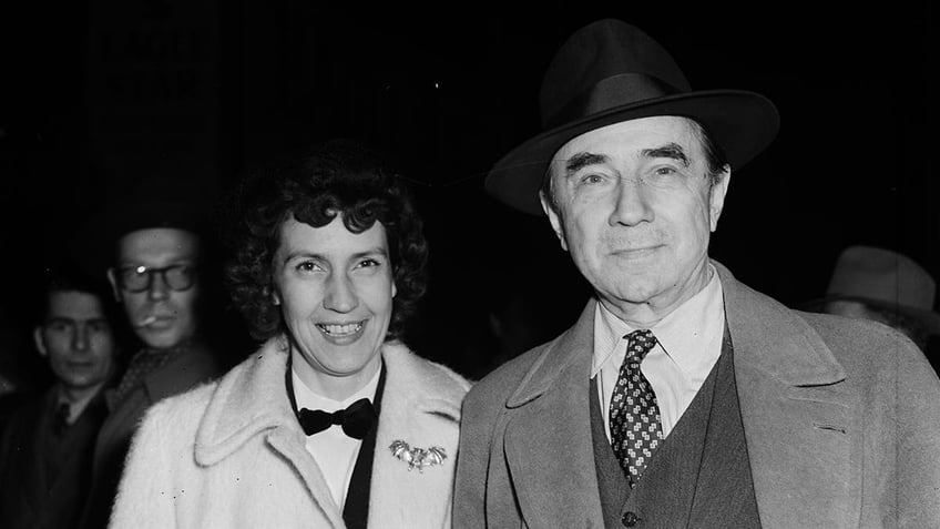 Bela Lugosi in a suit smiling next to Lillian also smiling to the camera.