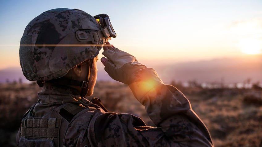 female soldier salutes