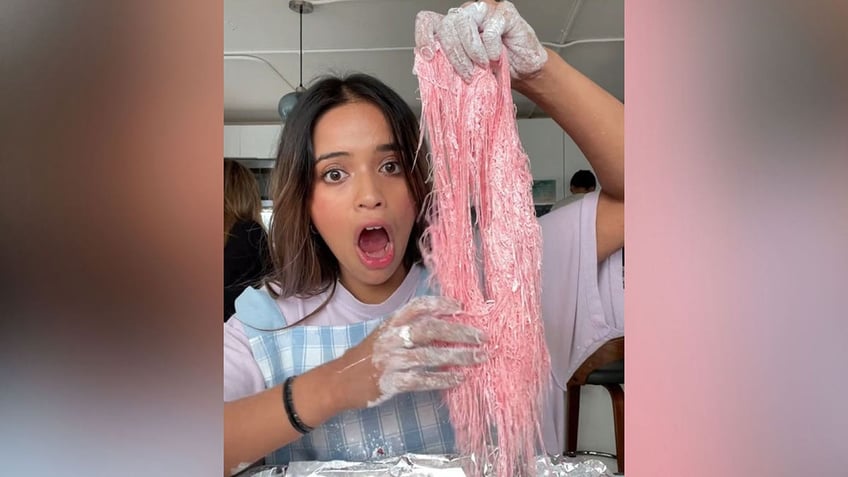 Woman holds homeade dragon's beard candy