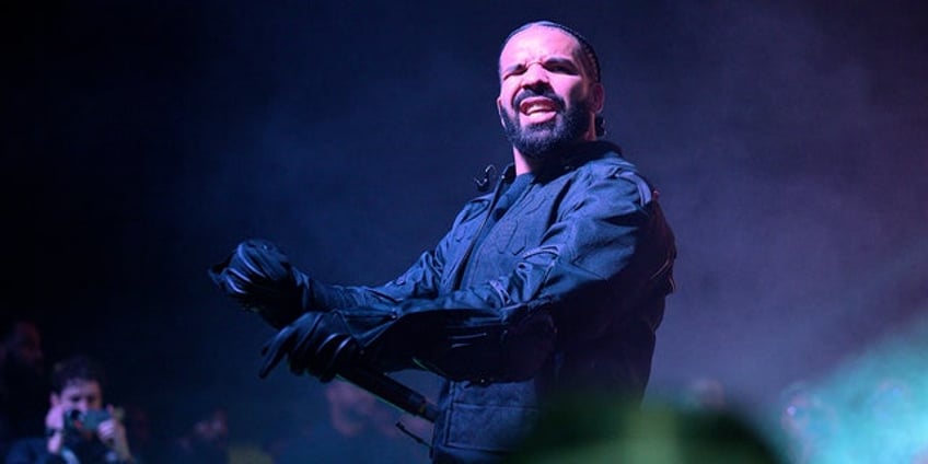 drake rushes to female fans aid as brawl breaks out after concert