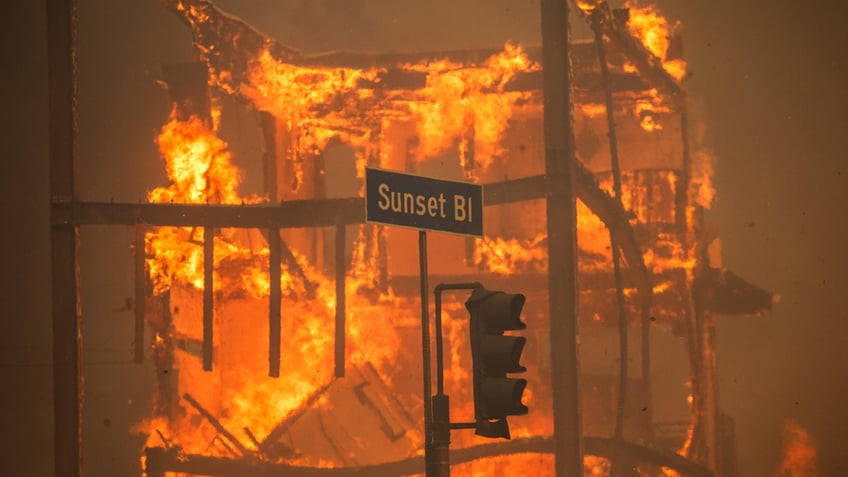 Flames from the Palisades Fire burn a building on Sunset Boulevard amid a powerful windstorm on January 8, 2025 in the Pacific Palisades neighborhood of Los Angeles, California. Fueled by intense Santa Ana Winds, the Palisades Fire has grown to over 15,000 acres and 30,000 people have been ordered to evacuate while a second major fire continues to burn near Eaton Canyon in Altadena.  (Photo by Apu Gomes/Getty Images)