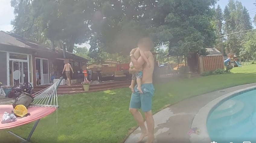 dramatic video shows michigan police officer helping save 2 year old spotted lifeless in pool