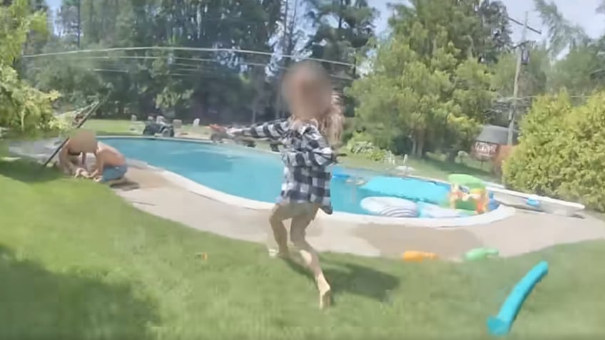 dramatic video shows michigan police officer helping save 2 year old spotted lifeless in pool