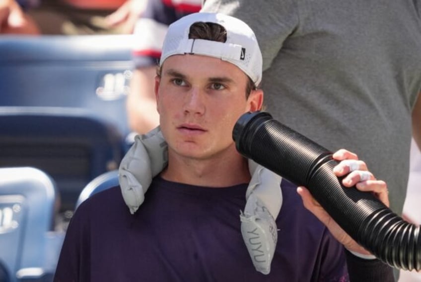 Model of consistency: Jack Draper cools off during his match against Tomas Machac