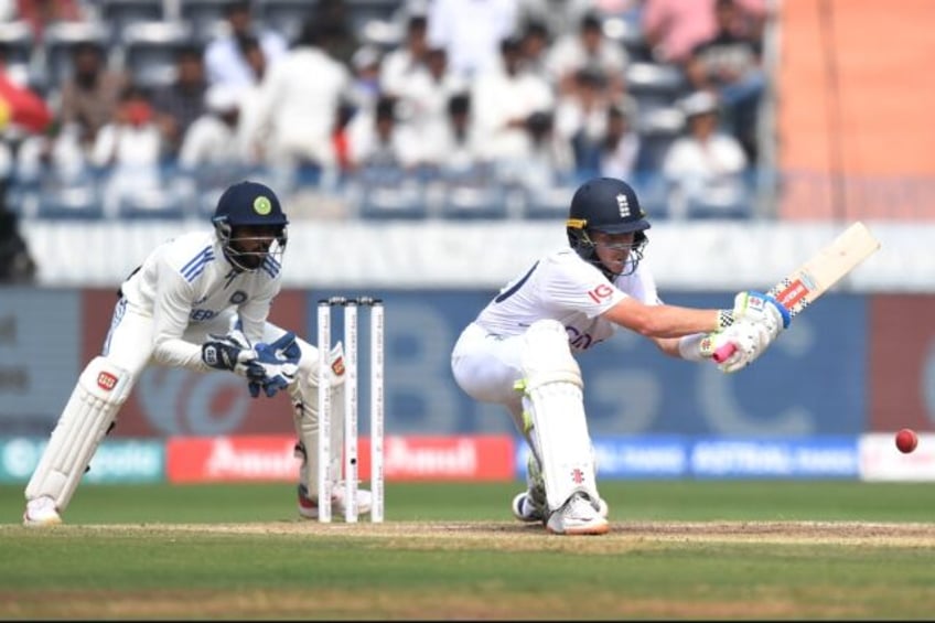 Ollie Pope lines up a reverse sweep as India's wicketkeeper Srikar Bharat watches