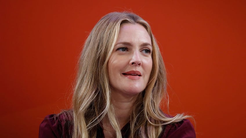 Drew Barrymore on a red background