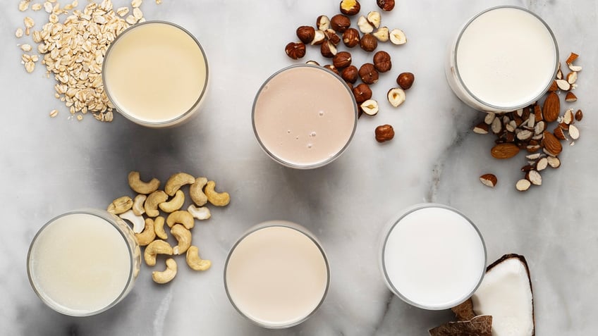 Alternatives to dairy milk are presented on a table.