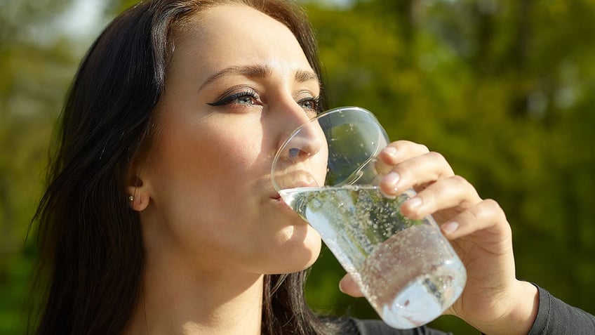 Woman with glass of sparkling water