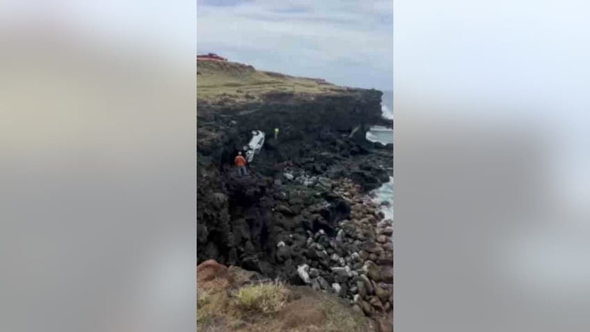 crews hauling car up cliff