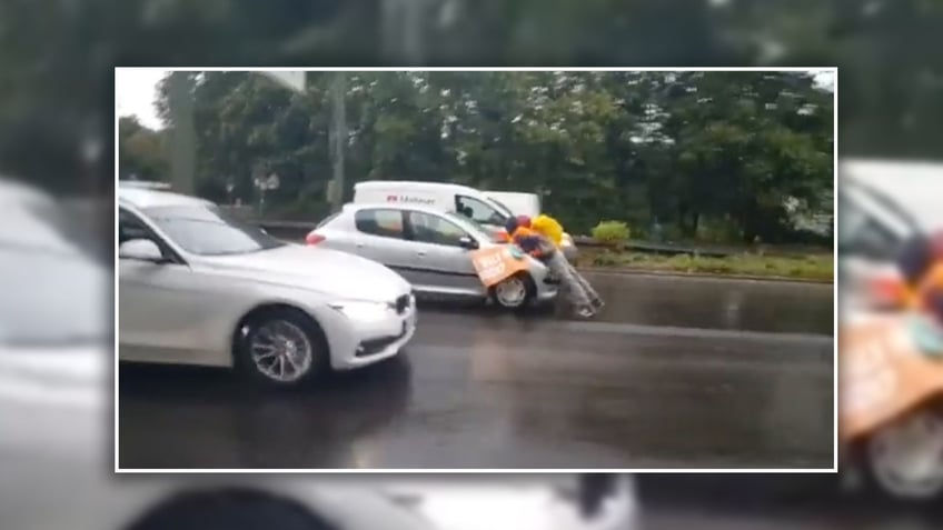 driver drags radical climate protesters through highway after they refuse to get out of way