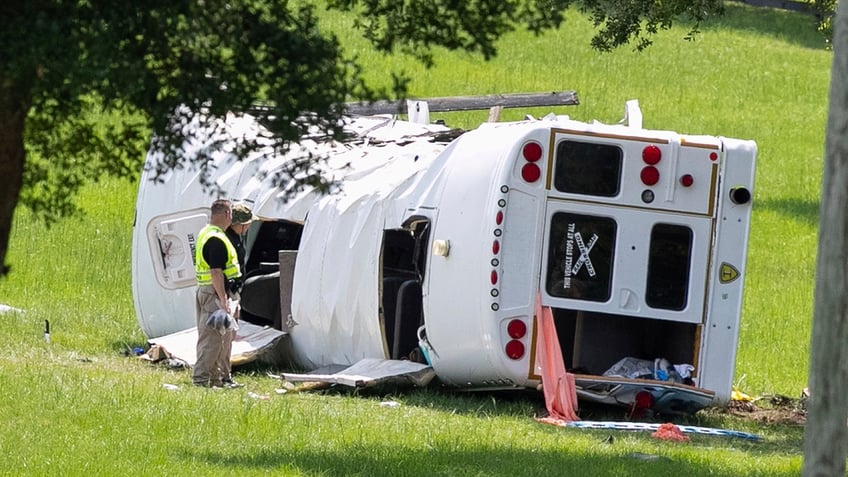 investigators standing next to bus