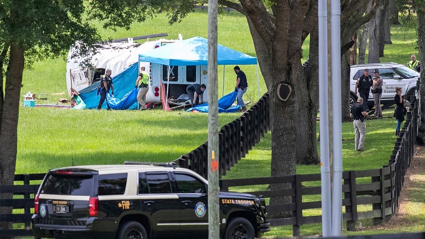 investigators standing next to bus