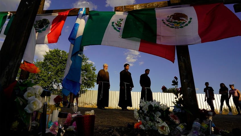 People at a makeshift memorial.