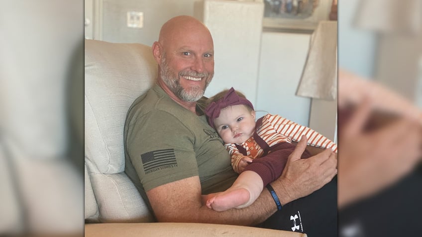 Pinal County Sheriff Mark Lamb holding his granddaughter