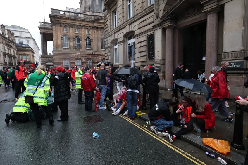 LIVERPOOL, ENGLAND - MAY 26: A large emergency service presence is pictured as members of the public react on Water Street during the Liverpool Trophy Parade on May 26, 2025 in Liverpool, England. (Photo by Getty Images)
