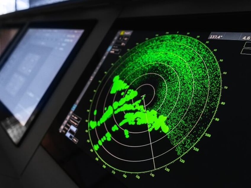 Radar screen with green display indication on a captains bridge of modern ship