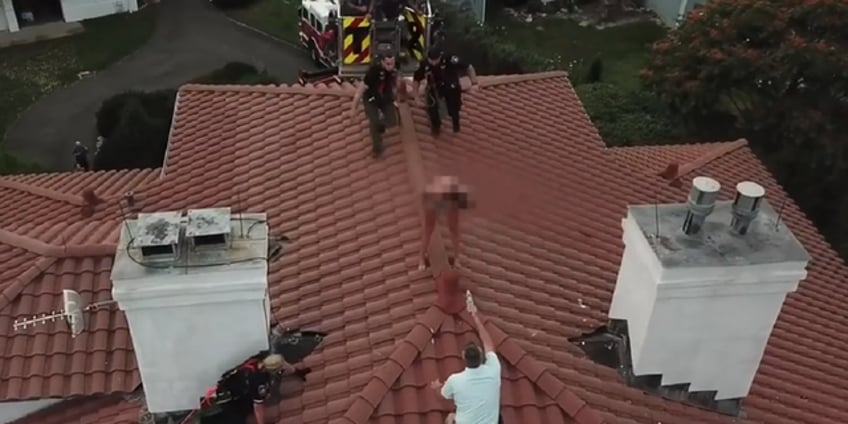 drone video shows officer scaling house to arrest suspected female intruder perched on roof