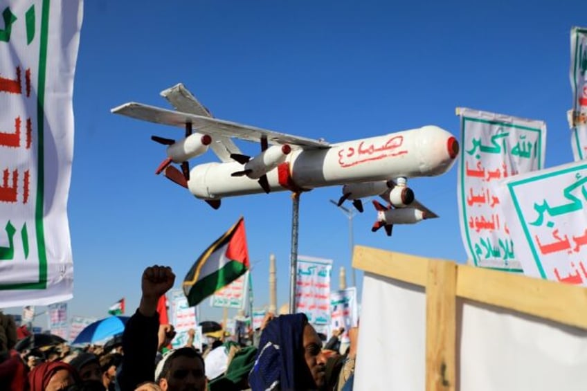 A demonstrator carries a mock drone during a rally in the Huthi-run Yemeni capital Sanaa o