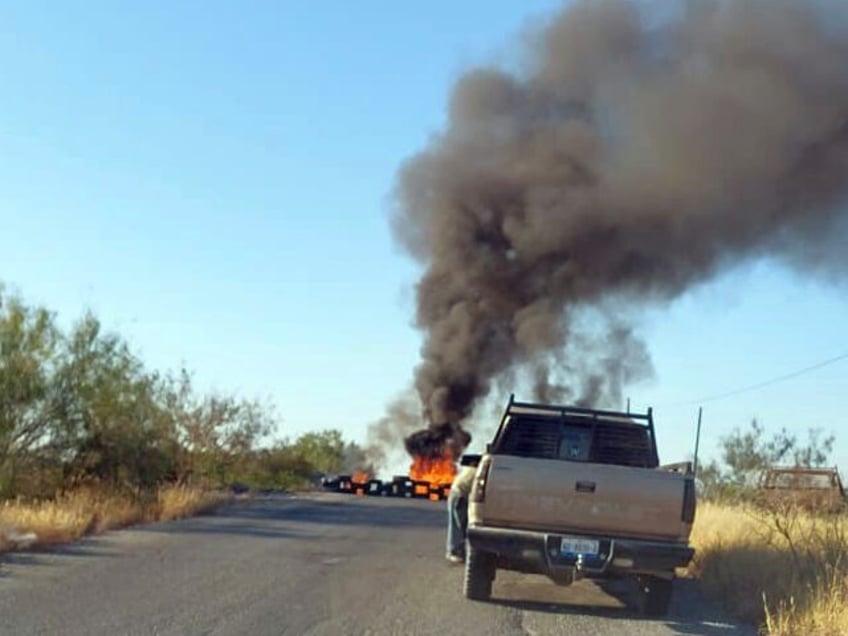 Cartel gunmen set up a blockade with burning tires in Tamaulipas. (Credit: Breitbart Texa