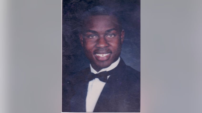 Robert Champion wearing a suit and bow tie for a class photo